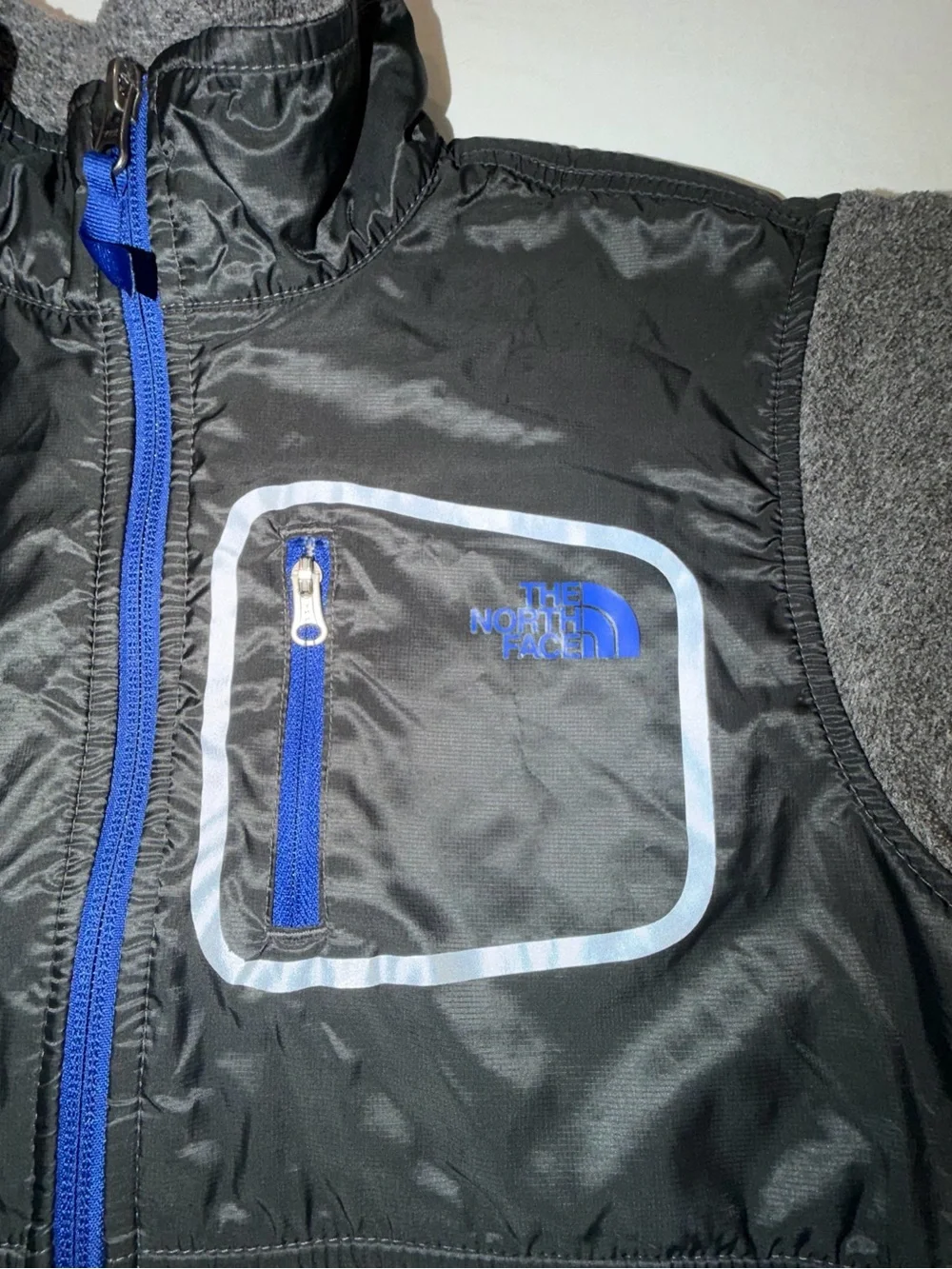 The North Face Kids Black and Gray Jacket with Blue Zip. C13,EMP